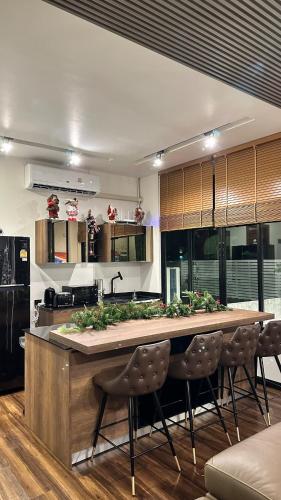 a kitchen with a large kitchen island with chairs at Alisto Khaoyai in Wangkata