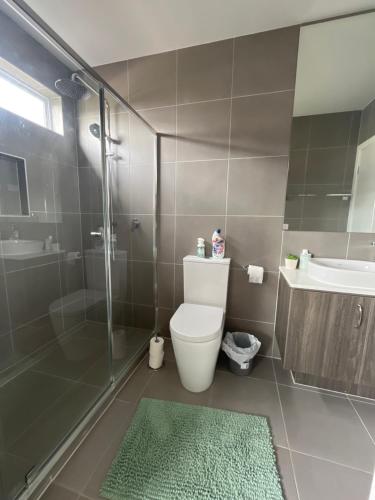 a bathroom with a toilet and a sink and a shower at Luxurious room stay- 25 min to Melbourne Airport and next to Hume Freeway in Wollert