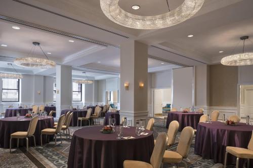 a banquet room with purple tables and chairs and chandeliers at The Ritz-Carlton, Philadelphia in Philadelphia