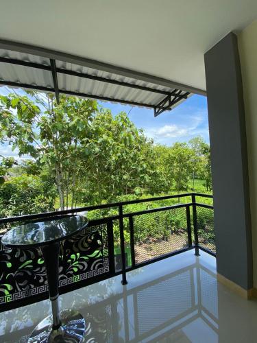 a room with a balcony with a view of trees at Wisma HN in Selang