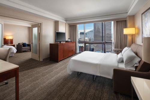 a hotel room with a large bed and a television at The Westin Cincinnati in Cincinnati