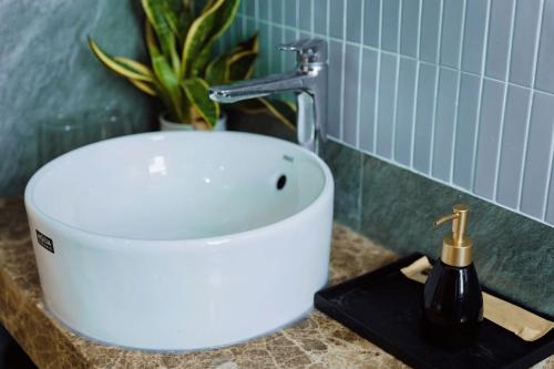 a bathroom sink with a faucet on a counter at Nami Homestay in HÆ°ng YÃªn