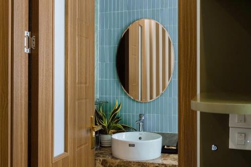 a bathroom with a sink and a mirror at Nami Homestay in HÆ°ng YÃªn