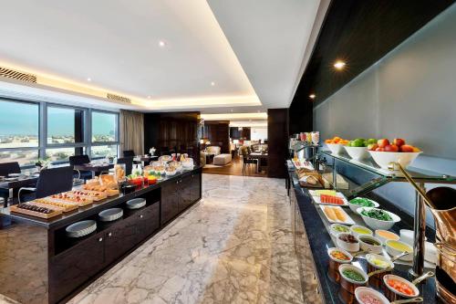 a buffet in a hotel with a lot of food at Marriott Hotel Al Forsan, Abu Dhabi in Abu Dhabi
