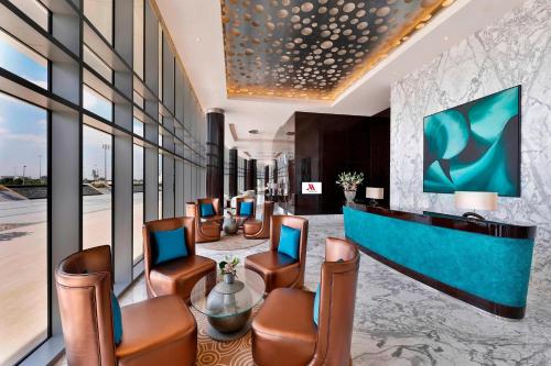 a hotel lobby with chairs and a reception desk at Marriott Hotel Al Forsan, Abu Dhabi in Abu Dhabi