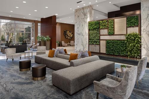 a lobby with couches and chairs and a wall with plants at The Westin Baltimore Washington Airport - BWI in Linthicum Heights