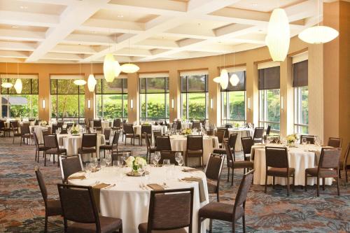 a banquet hall with tables and chairs and windows at The Westin Baltimore Washington Airport - BWI in Linthicum Heights