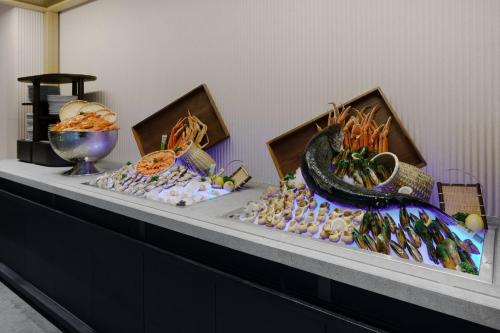 a table with a buffet of food on it at HUALUXE Shenzhen Bao'an in Shenzhen