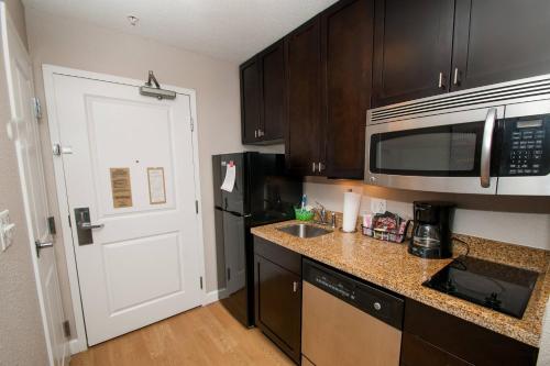 a kitchen with a counter and a microwave and a door at TownePlace Suites by Marriott Scranton Wilkes-Barre in Moosic