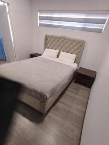 a bed in a small room with a window at Nice 2 bedroom apartment in Kelmscott