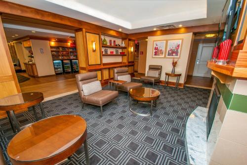 a lobby with a waiting area with chairs and tables at TownePlace Suites by Marriott Scranton Wilkes-Barre in Moosic
