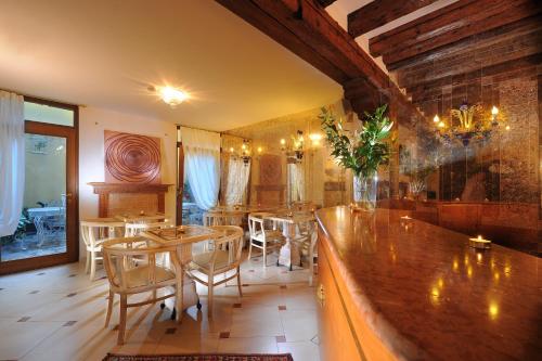 a restaurant with a bar with tables and chairs at Ca' Pagan in Venice
