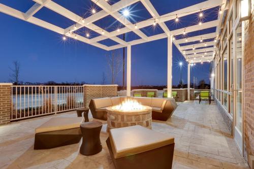 a patio with a fire pit on a building at SpringHill Suites by Marriott Dallas Mansfield in Mansfield