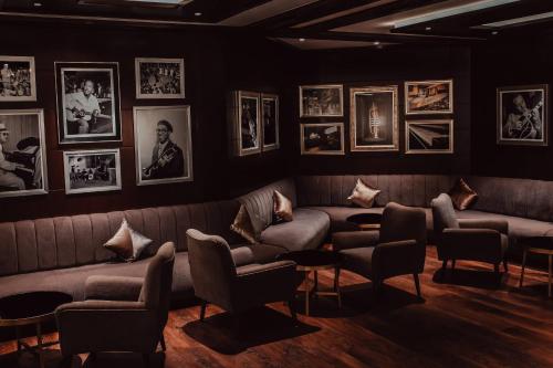 a waiting room with couches and pictures on the wall at Al Bustan Palace, a Ritz-Carlton Hotel in Muscat