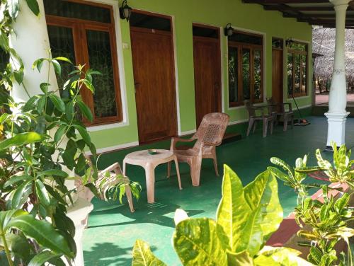 a porch of a house with chairs and plants at SIGIRI HUNTER'S HOMESTAY & Hostel in Sigiriya