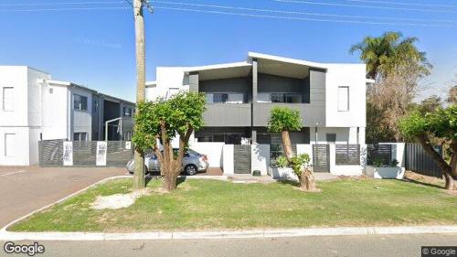a white house with a car parked in front of it at Nice 2 bedroom apartment in Kelmscott