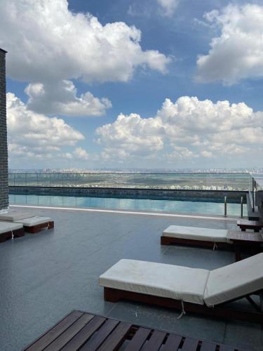a swimming pool with benches on the roof of a building at Days Inn & Suites by Wyndham Esenyurt in Istanbul