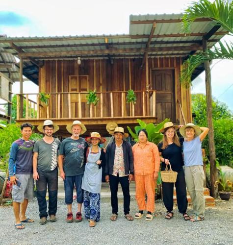 a group of people standing in front of a house at Battambang Eco Stay &cooking class in Battambang
