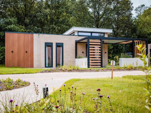 a house with a modern design with a driveway at Spacious holiday home in Voorhuizen with terrace in Voorthuizen