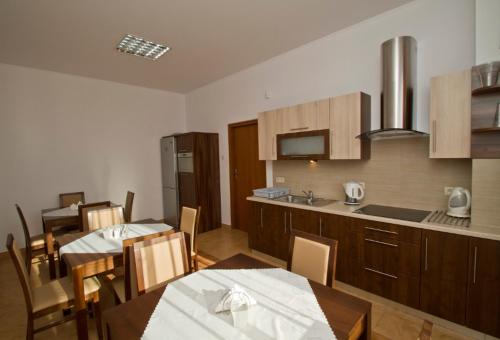 a kitchen and dining room with a table and chairs at Willa Bystra in Kościelisko