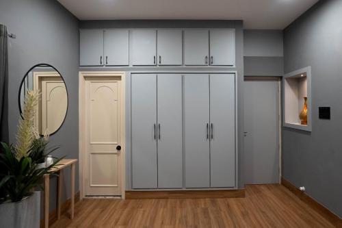 a room with white cabinets and a mirror at The Lavish Affair in Bhuj
