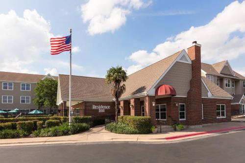 a building with an american flag in front of it at Residence Inn by Marriott Austin The Domain Area in Austin