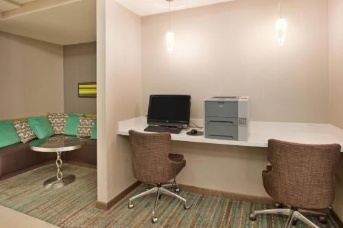 a room with a desk with a computer and two chairs at Residence Inn by Marriott Austin Round Rock/Dell Way in Round Rock