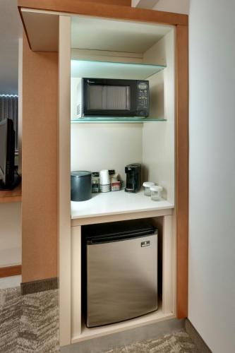a small kitchen with a microwave and a stove at SpringHill Suites by Marriott Rexburg in Rexburg