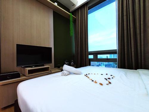 a hotel room with a bed with a heart made out of roses at No Other Fee #Swiss Garden Residences by The Boston House #Bukit Bintang in Kuala Lumpur