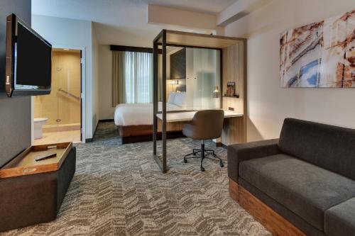 a hotel room with a couch and a bed at SpringHill Suites by Marriott Birmingham Downtown at UAB in Birmingham