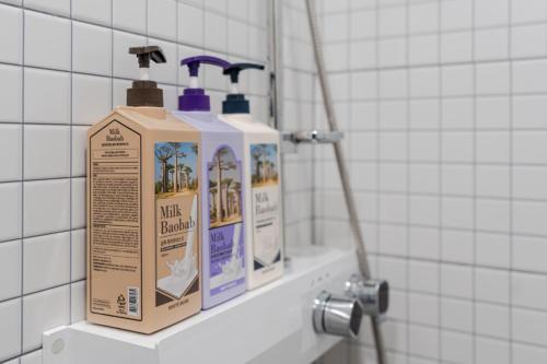 two bottles of hair products sitting on a shelf in a bathroom at 32평자쿠지독채 지금애월 in Jeju
