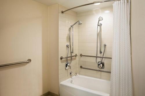 a bathroom with a bath tub with a shower curtain at The Westin Waltham Boston in Waltham