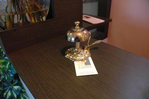 a table with a gold lamp on top of it at Hotel 4 Strade in Ortona