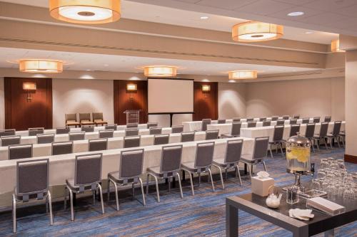 a conference room with rows of chairs and a whiteboard at The Westin Waltham Boston in Waltham
