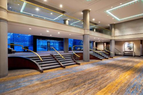 a large lobby with stairs and a stage at The Westin Waltham Boston in Waltham