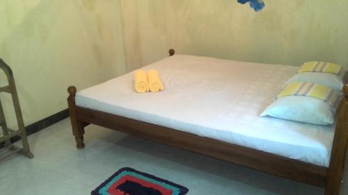 a bedroom with a bed with two pillows on it at veranda guest home in Mirissa