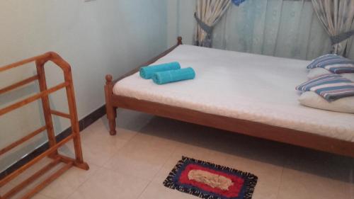 a small bedroom with a bed and a chair at veranda guest home in Mirissa