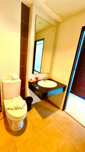 a bathroom with a toilet and a sink at KS Residence Patong in Patong Beach