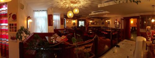 a living room with a couch and a table at Hotel MANTOVA Vrhnika in Vrhnika