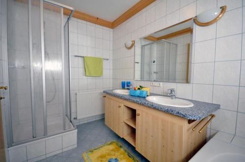 a bathroom with a sink and a shower at Appartements Familie Grundner in Leogang