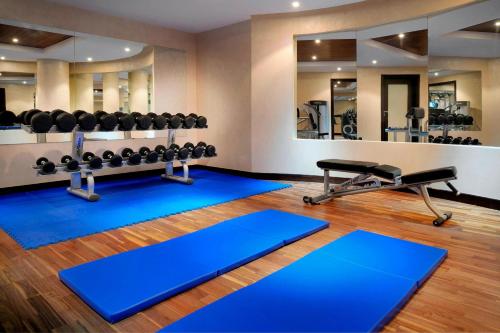a fitness room with a gym with weights at Residence Inn by Marriott Manama Juffair in Manama
