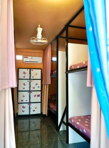 a room with two bunk beds and a ceiling at Garden Bungalows Koh Rong in Koh Rong