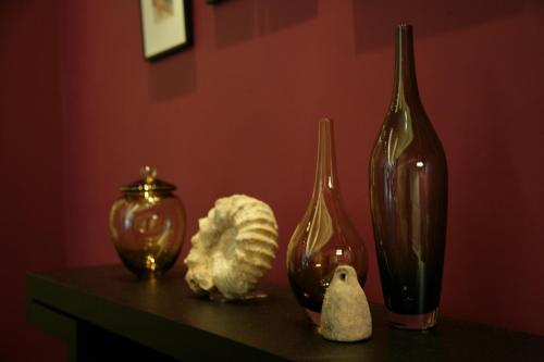 a table with three glass vases and other items on it at Hotel Gracery Tokyo Tamachi in Tokyo