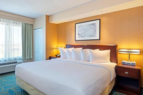 a hotel room with a large bed and a window at SpringHill Suites Boulder Longmont in Longmont