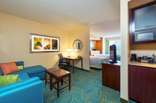 a hotel room with a couch and a bed at SpringHill Suites Boulder Longmont in Longmont