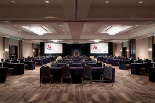 a conference room with tables and chairs and screens at Miami Marriott Dadeland in Miami