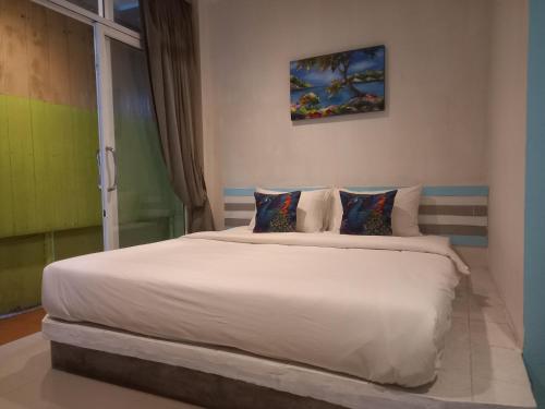 Ένα ή περισσότερα κρεβάτια σε δωμάτιο στο Hotel Rung Phangan