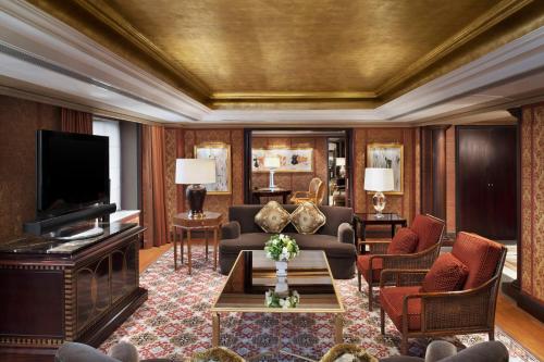 a living room with a couch and a tv at The St. Regis Beijing in Beijing