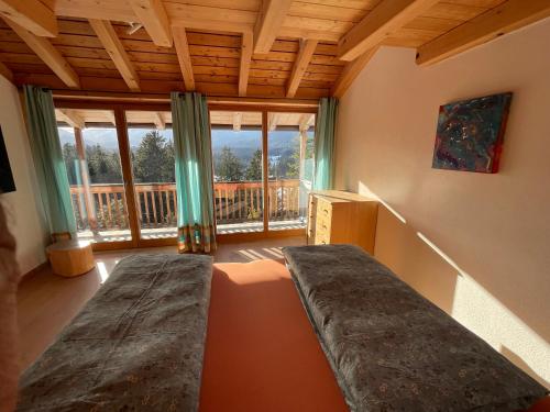 a room with a bed and a large window at Traumhaus sensationeller Lage Traumhafter Bergblick absolute Ruhe in Fischbachau