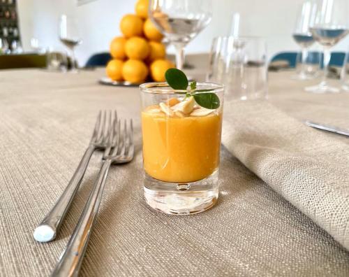 a glass of orange juice sitting on top of a table at Fantastic Garden - Firenze Nord in Sesto Fiorentino